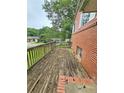 View of exterior wooden deck with brick home at 6616 King George Way, Morrow, GA 30260