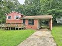 Exterior of two-story home featuring front deck and covered parking at 6616 King George Way, Morrow, GA 30260