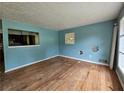 Living room featuring wood floors, blue walls, and window at 6616 King George Way, Morrow, GA 30260