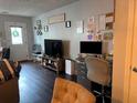 Cozy living area with wood floors, a television, and a well-lit workspace at 6620 Wellington Sq, Norcross, GA 30093