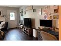 Comfortable living room with dual monitors and work space near an outdoor-facing door at 6620 Wellington Sq, Norcross, GA 30093