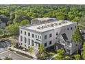 Aerial view showcasing modern condominium building, lush greenery, and well-manicured landscape at 108 Park Place Unit 107, Decatur, GA 30030