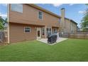 Spacious backyard featuring a well-maintained lawn and patio space, perfect for outdoor entertaining at 1267 Castleberry Dr, Buford, GA 30518