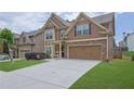 Charming exterior showcasing the home's facade, attached garage, and lovely landscaping on a sunny day at 1267 Castleberry Dr, Buford, GA 30518