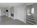 Stylish living area showcasing contemporary flooring, fireplace, staircase, and open layout to kitchen at 4701 Flat Shoals Rd # 50A, Union City, GA 30291