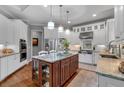 Bright and modern kitchen featuring white cabinetry, granite countertops, stainless steel appliances, and a center island at 1220 Waterfall Nw Ln, Acworth, GA 30101