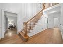 Spacious entry foyer with hardwood floors, a staircase, and white molding at 2010 Pearwood Path, Roswell, GA 30076