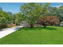 Lovely one-story home featuring mature trees and a spacious green lawn at 2060 Panstone Sw Ct, Marietta, GA 30060