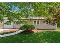 Quaint one-story home with a vibrant green lawn and mature landscaping at 2060 Panstone Sw Ct, Marietta, GA 30060