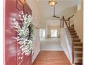 Inviting foyer with hardwood floors, a staircase, and views into the living area, highlighting the home's layout at 3585 Berkeley Park Ct, Duluth, GA 30096