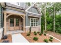 Inviting entrance exhibiting an arched doorway with stylish brick accents at 7080 Driskell Cir, Cumming, GA 30041