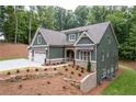 Attractive home featuring a three-car garage and professional landscaping at 7080 Driskell Cir, Cumming, GA 30041