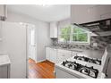 Functional kitchen with white appliances, hardwood floors, and lots of natural light at 1891 8Th St, Atlanta, GA 30341