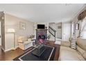 Comfortable living room featuring hardwood floors, a brick fireplace, and ample natural light at 244 Timber Creek Sw Ln, Marietta, GA 30060
