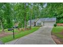 Well-maintained home featuring a long driveway, lush lawn, and attractive landscaping at 3286 Crawford Cir, Marietta, GA 30066