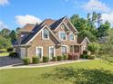 Charming brick home with lush green lawn and neatly trimmed bushes at 2900 Sutton Pl, Conyers, GA 30013