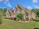 Beautiful two-story brick home with a well-manicured lawn at 2900 Sutton Pl, Conyers, GA 30013