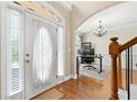 Welcoming foyer with hardwood floors and a view into an office space with natural light at 2900 Sutton Pl, Conyers, GA 30013