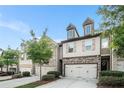 Charming townhome with stone accents, a two-car garage, and well-maintained landscaping at 2909 Emme Ct, Conyers, GA 30094