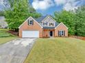 Beautiful two-story brick home featuring a well-maintained lawn and attached garage at 3190 Water Brook Sw Dr, Conyers, GA 30094