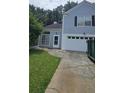 Charming two-story home with blue siding, white trim, and an attached garage at 4965 N Bridges Dr, Alpharetta, GA 30022