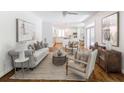 Bright living room featuring hardwood floors, neutral paint, and seamlessly connects to a modern kitchen at 710 Greystone Ne Park, Atlanta, GA 30306