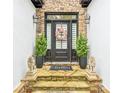 Welcoming front entrance with stone accents, potted plants, and a decorative wreath at 827 Holly Rdg, Canton, GA 30115