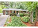 Charming brick home with mature landscaping, black shutters, and a welcoming front porch at 2197 Fairway Ne Cir, Brookhaven, GA 30319
