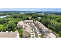 Aerial view of townhomes with a lake and lush greenery at 2340 Manor Pointe Dr, Cumming, GA 30041