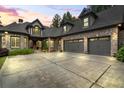 Gorgeous brick home featuring a three-car garage and meticulously maintained landscaping and a large driveway at 241 Russell Rd, Lawrenceville, GA 30043