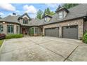 Gorgeous brick home featuring a three-car garage and meticulously maintained landscaping and a large driveway at 241 Russell Rd, Lawrenceville, GA 30043