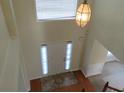 Bright foyer with a hanging light fixture and tile flooring at 804 Bridle Cove, Stockbridge, GA 30281