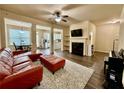 Open-concept living room with a fireplace, plush rug, modern furniture, and plenty of natural light at 2351 Attewood Dr, Buford, GA 30519