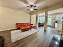 Bright living room featuring hardwood floors, an area rug, and open access to the kitchen at 2351 Attewood Dr, Buford, GA 30519