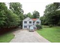 Inviting home with a long driveway, well-manicured lawn, and mature trees, offering a serene setting at 236 Hiram Sudie Rd, Dallas, GA 30157
