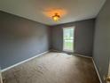 Comfortable bedroom featuring neutral walls, a window for natural light, and standard ceiling light fixture at 134 Summer Lake Dr, Dallas, GA 30157