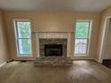 Living room showcasing a stone fireplace, flanked by two large windows providing ample natural light at 134 Summer Lake Dr, Dallas, GA 30157