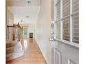 Inviting foyer with hardwood floors, staircase, and view into the living area with a fireplace at 1666 Oakbrook Lake Dr, Norcross, GA 30093