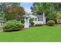 Charming single-story home with a well-manicured lawn, inviting curb appeal, and mature trees at 1680 Bristol Dr, Atlanta, GA 30329