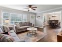 Bright living room featuring wood floors, a large window, and views of the dining area at 1680 Bristol Ne Dr, Atlanta, GA 30329