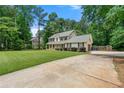Long driveway leading to this two-story home in a quiet, wooded lot at 2750 Briarfield Way, Lawrenceville, GA 30043