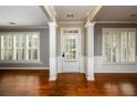 Bright foyer with hardwood floors, white trim, and large windows providing ample natural light at 4916 Gathering Pl, Suwanee, GA 30024