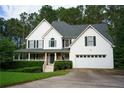 Charming two-story home with a well-maintained lawn and attached two car garage at 111 Bexley Ln, Douglasville, GA 30134