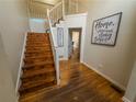 Bright foyer features hardwood floors, staircase, and decor, creating a welcoming entrance to the home at 111 Bexley Ln, Douglasville, GA 30134