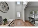 Bright foyer with light hardwood floors, high ceilings, and a decorative wall hanging at 4495 Hedgewood Dr, Cumming, GA 30041