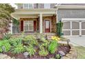 Landscaped front yard leading up to the stone-accented porch and red front door at 4495 Hedgewood Dr, Cumming, GA 30041