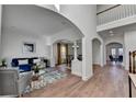 Open-concept living room with hardwood floors, white trim, and a view of the dining area at 4495 Hedgewood Dr, Cumming, GA 30041