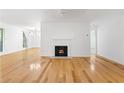 Open-concept living space with hardwood floors, fireplace, and ample lighting for a modern appeal at 1105 Pine Heights Ne Dr, Atlanta, GA 30324