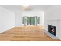 Spacious living room features hardwood floors, a fireplace, and sliding doors to the outside at 1105 Pine Heights Ne Dr, Atlanta, GA 30324