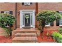 Elegant front entryway with a decorative wreath, sidelights and mature landscaping at 2530 Ashbourne Dr, Lawrenceville, GA 30043
